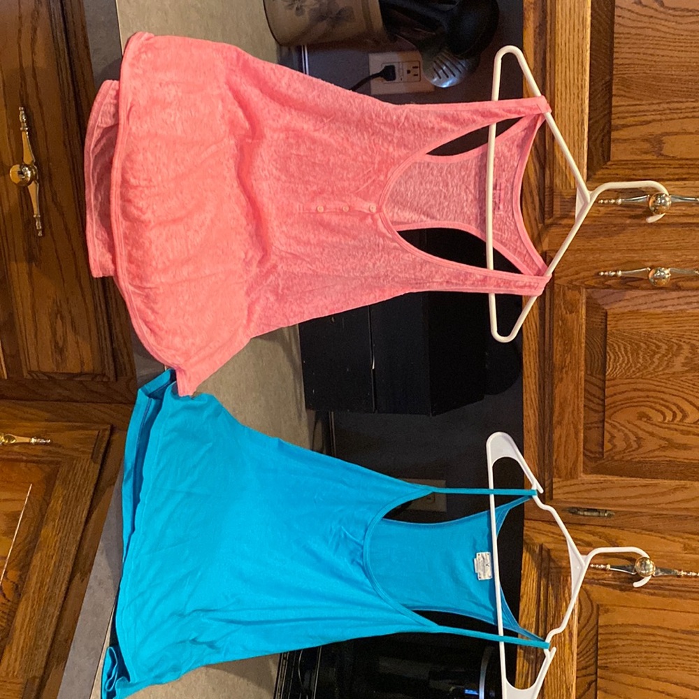 Two American eagle tanks. Like new. One is coral and one is teal